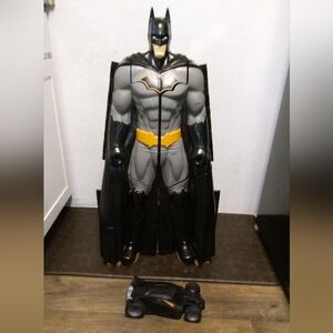 Black and Gray Superhero Figure with Car